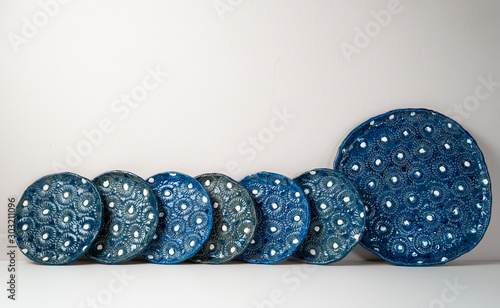 Handmade, crafted ceramic plate set with blue and white bump pattern