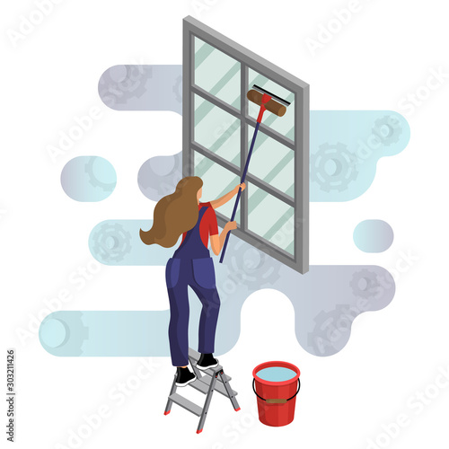 Young woman in overalls washes the window, standing on a stepladder