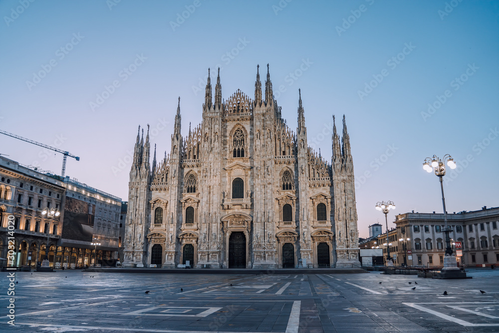 Early morning view of Milano Duomo Cathedral with pigeons in Milan, Italy