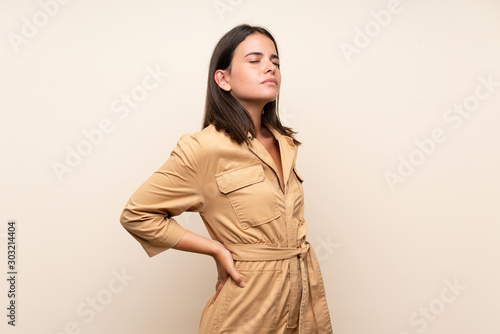 Young girl over isolated background suffering from backache for having made an effort
