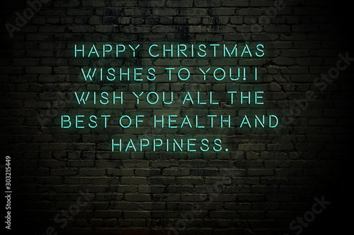 Neon inscription of christmas and new year greetings on brick wall