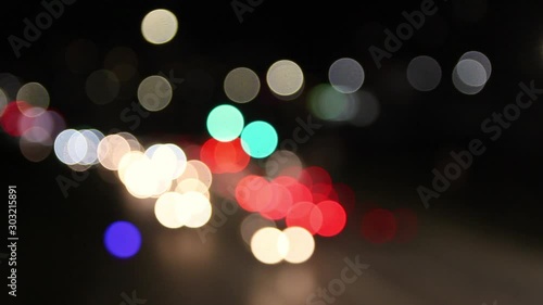 defocused blurry red white yellow car lights ,oving on city streen in the evening after dusk photo