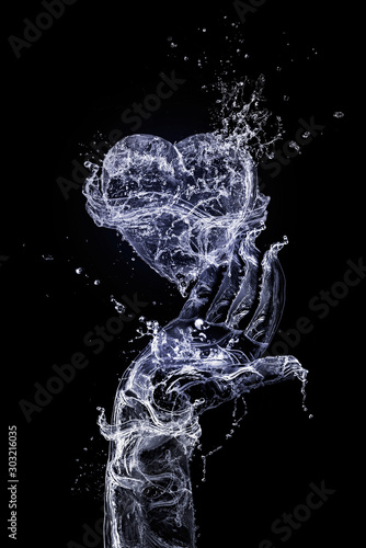 The hand made of water is keeping heart made of water on the black background. Happy Valentine's Day