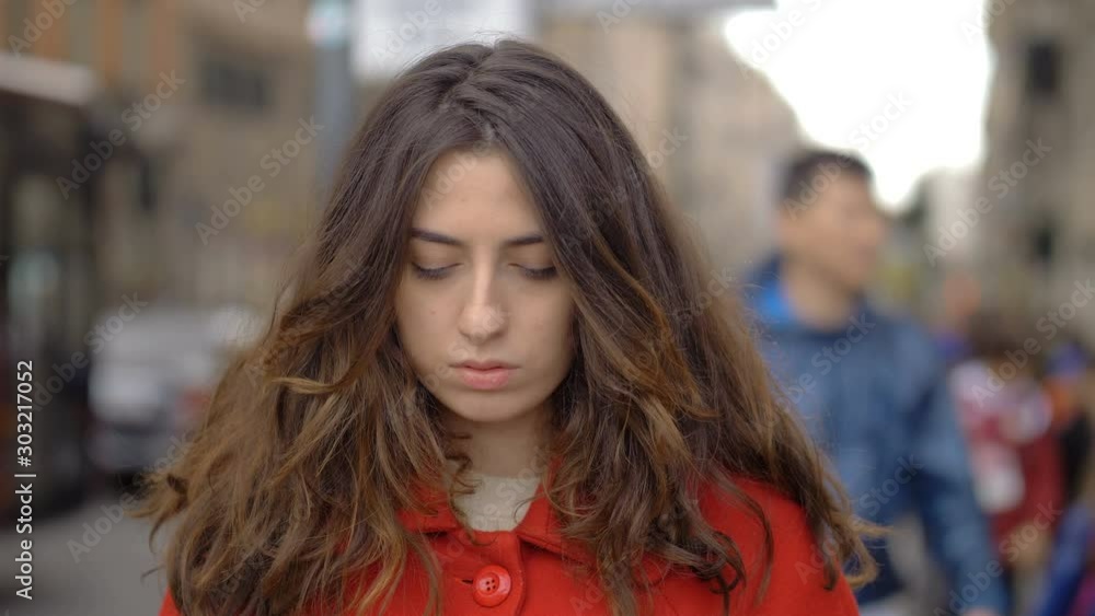 serious angry attractive young woman in the street,staring at camera serious angry attractive young woman in the street,staring at camera