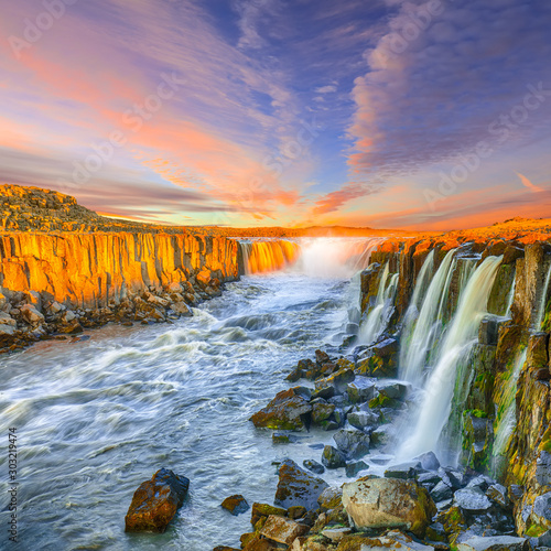 Dramatic sunset view of fantastic waterfall and cascades of Selfoss waterfall. © pilat666