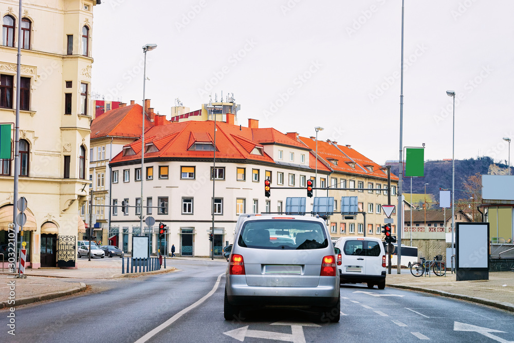 Car at road in Maribor in Slovenia. Building architecture on background. Cityscape and street view