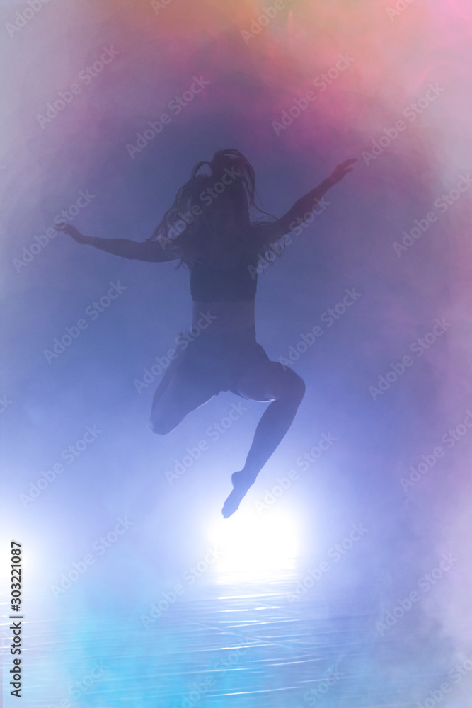 Young modern dancer dancing in the studio. Sport, dancing and urban culture concept. Group of young dancers performing on the stage. Effective performance. beautiful dance. Young modern dancer dancing in the studio. Sport, dancing and urban culture concept. Group of young dancers performing on the stage. Effective performance. beautiful dance.