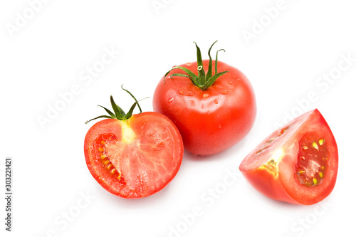 fresh ripe organic tomatoes in dew drops isolated on a white background