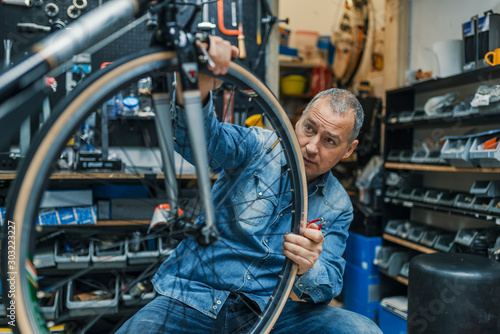 Bike mechanic repairing a wheel © Dragana Gordic