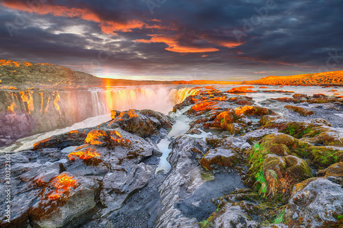 Fototapeta Naklejka Na Ścianę i Meble -  Dramatic sunset view of fantastic waterfall and cascades of Selfoss waterfall.