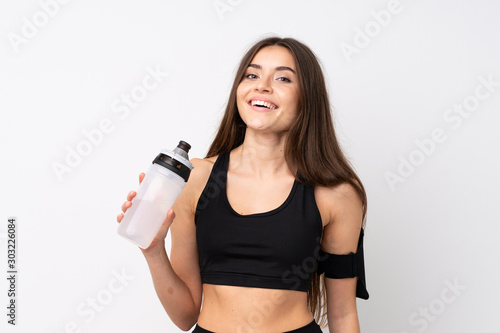 Young sport woman over isolated white background with sports water bottle