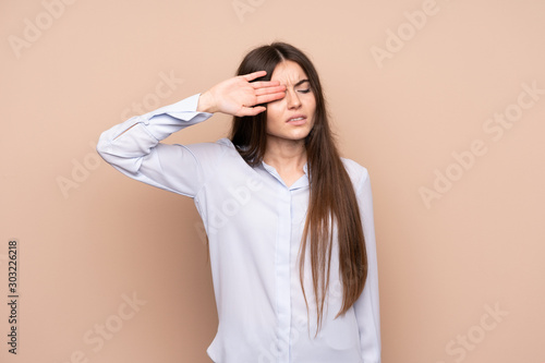 Young woman over isolated background with tired and sick expression