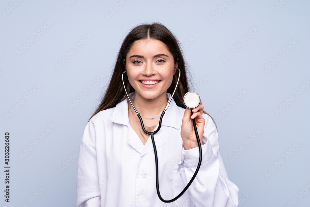 Young woman over isolated blue background with doctor gown Young woman over isolated blue background with doctor gown