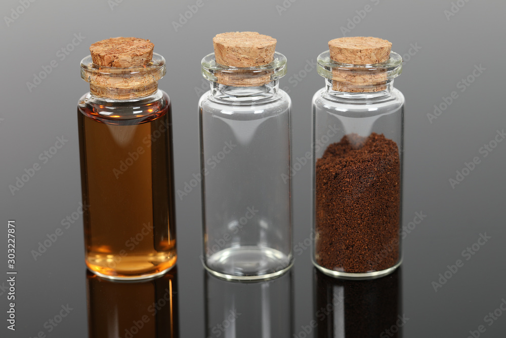 A number of small glass bottles with powders and liquids. A number of small glass bottles with powders and liquids.