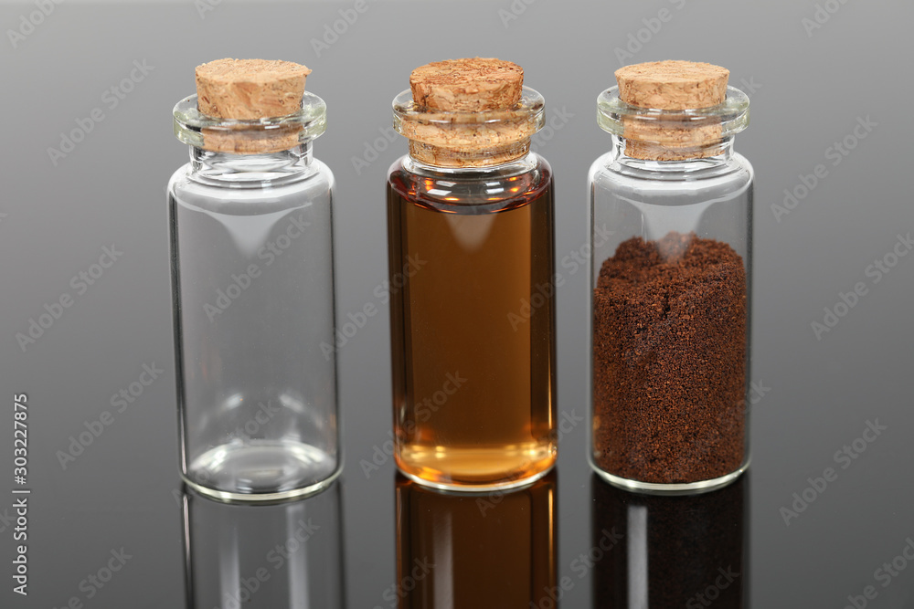 A number of small glass bottles with powders and liquids. A number of small glass bottles with powders and liquids.