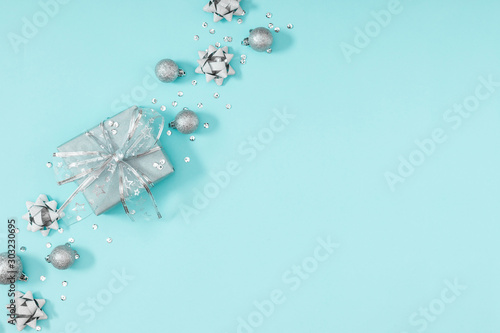 Christmas holiday composition. Silver decorations on pastel blue background. Christmas, New Year, winter concept. Flat lay, top view, copy space