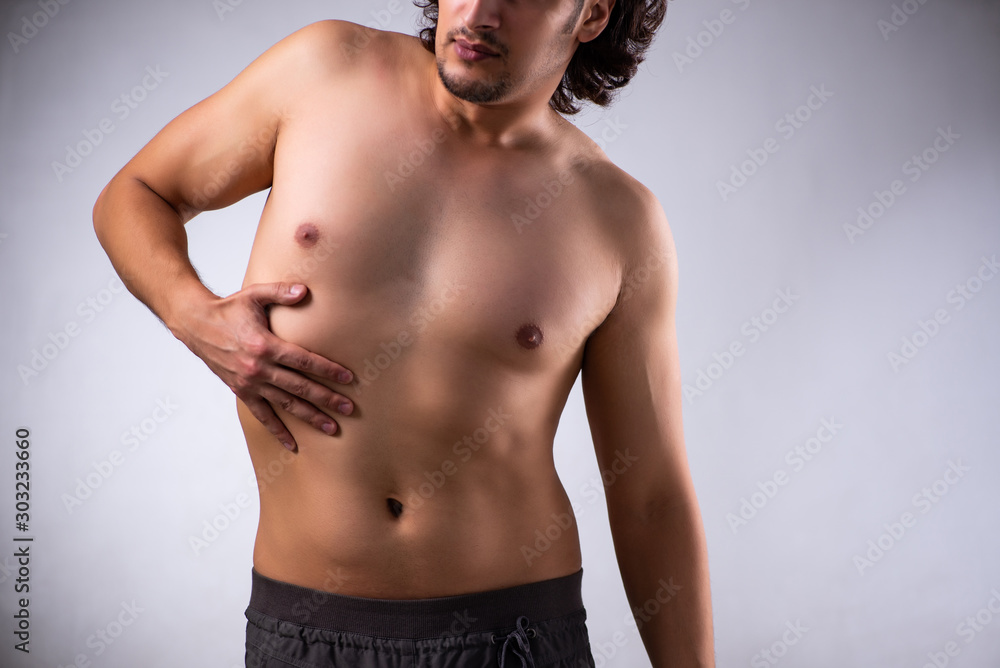 Fototapeta premium Young man suffering from stomachache