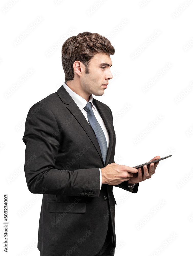 Serious young businessman with tablet, isolated Serious young businessman with tablet, isolated