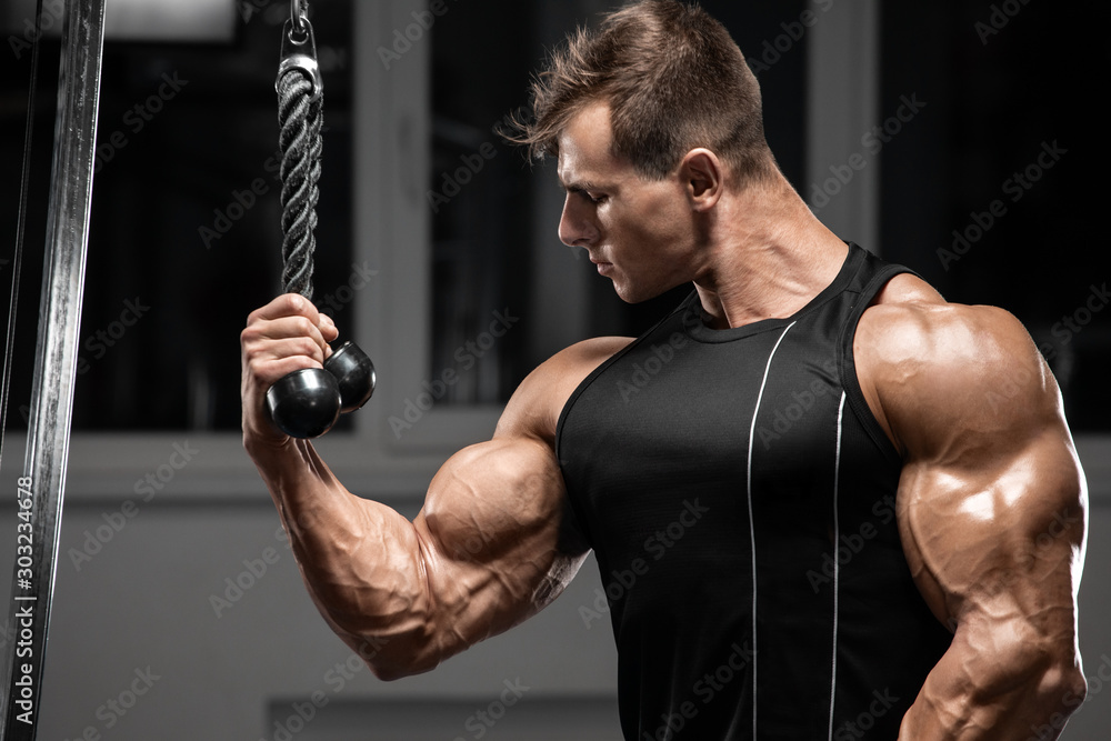 Stockfoto med beskrivningen Muscular man workout in gym doing exercises for  biceps, strong bodybuilder male showing biceps | Adobe Stock