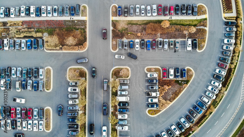 An aerial view of cars in a large parking lot during the holiday season