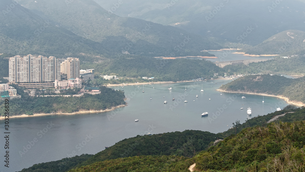 Obraz premium Landscape viewed on the ridge of dragons's back in Hong kong, this is a famous hiking route to enjoy rural life in modern city.