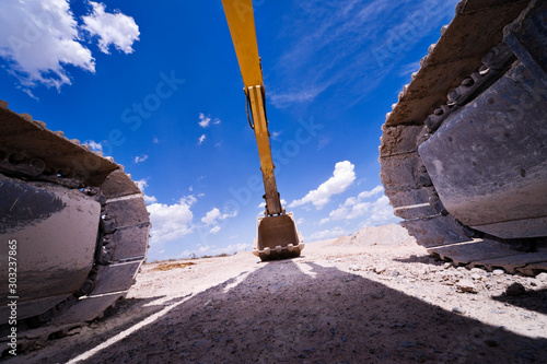Heavy Construction Equipment Hydraulic Excavator against a cloudy sky