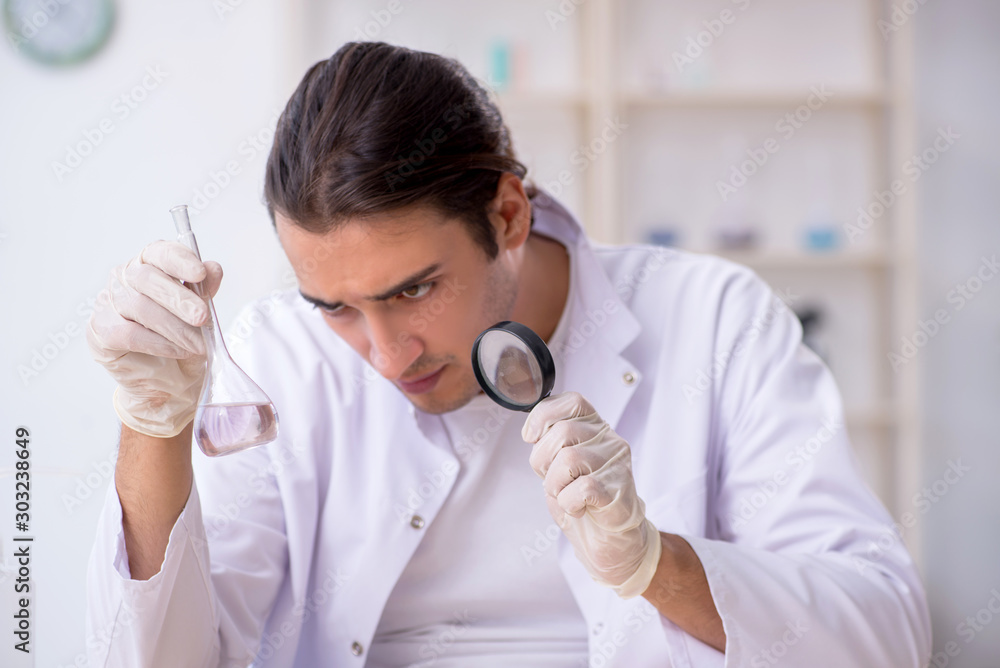 Young male chemist working in the lab Young male chemist working in the lab