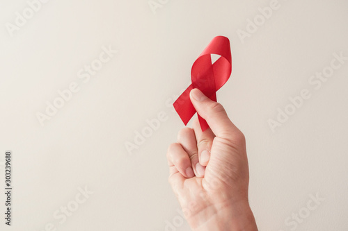 Tableau sur toile Hand holding red ribbon, hiv awareness concept, world AIDS day, world hypertensi