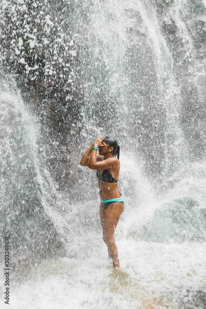 Woman under waterfall, on the bottom of rocks and river. Woman under waterfall, on the bottom of rocks and river.