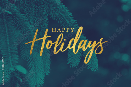 Gold Happy Holidays Christmas Calligraphy Script with Tree Evergreen Background