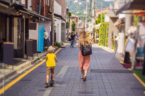 Photography Mom and son tourists in Bukchon Hanok Village is one of the famous place for Korean traditional houses have been preserved