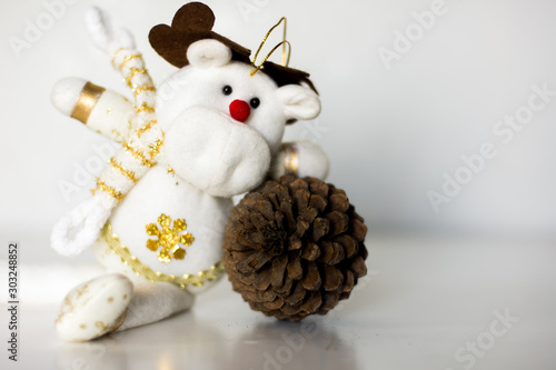 Pine cone and Christmas teddy bear in white background