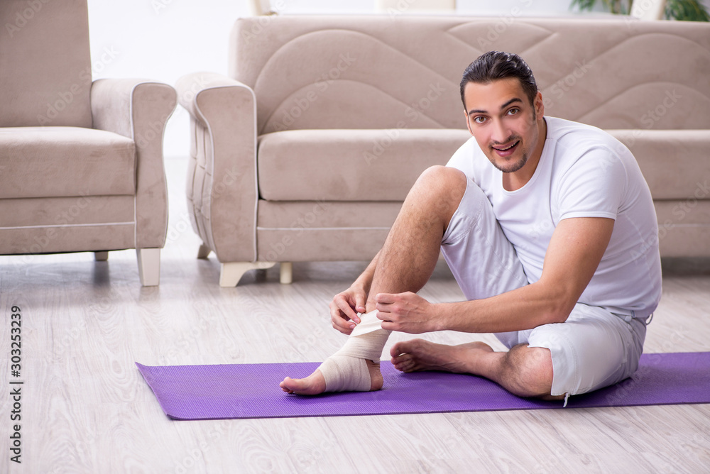 Leg injured man doing exercises at home Leg injured man doing exercises at home