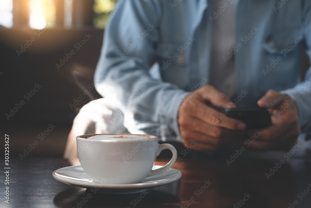 Man using mobile phone and coffee - obrazy, fototapety, plakaty 