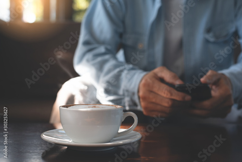 Man using mobile phone and coffee