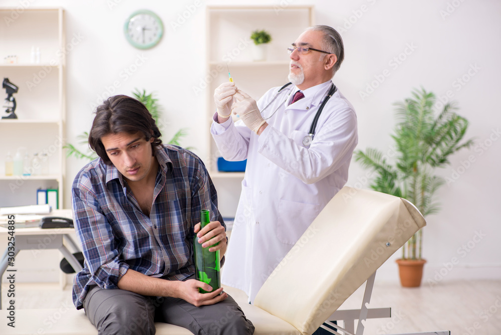 Young male alcoholic visiting old doctor Young male alcoholic visiting old doctor