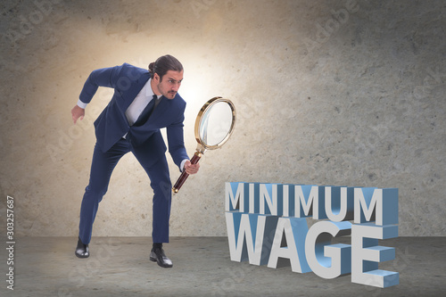 фотографія Concept of minimum wage with businessman