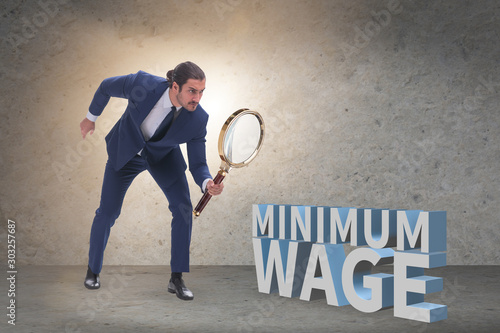 Concept of minimum wage with businessman photo