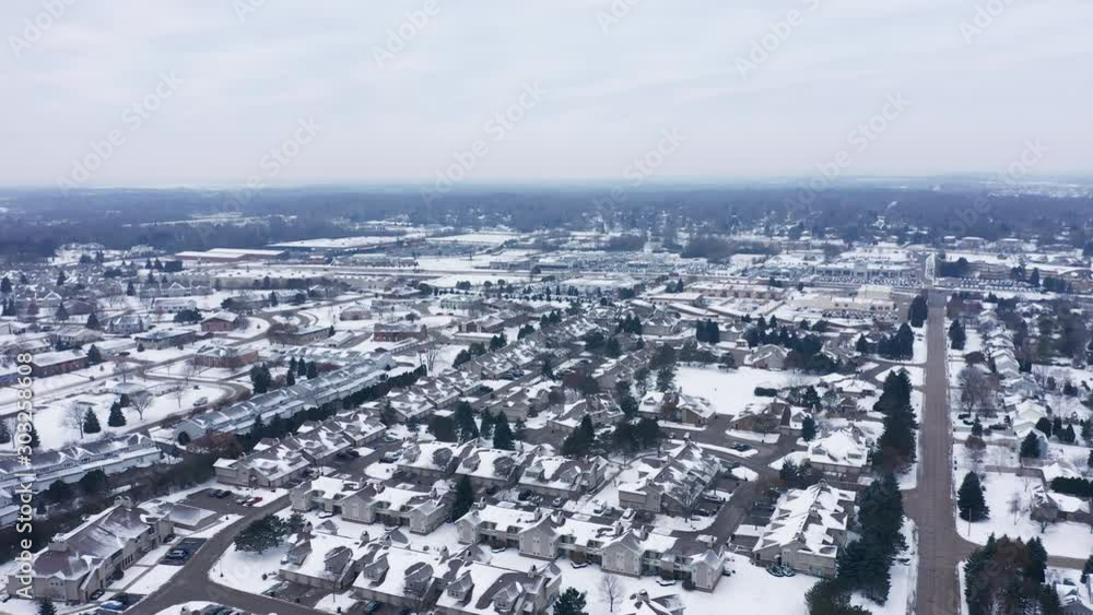 Aerial view of residential houses covered first snow. American neighborhood, suburb. Real estate, drone shots, day time, winter, from above Aerial view of residential houses covered first snow. American neighborhood, suburb. Real estate, drone shots, day time, winter, from above
