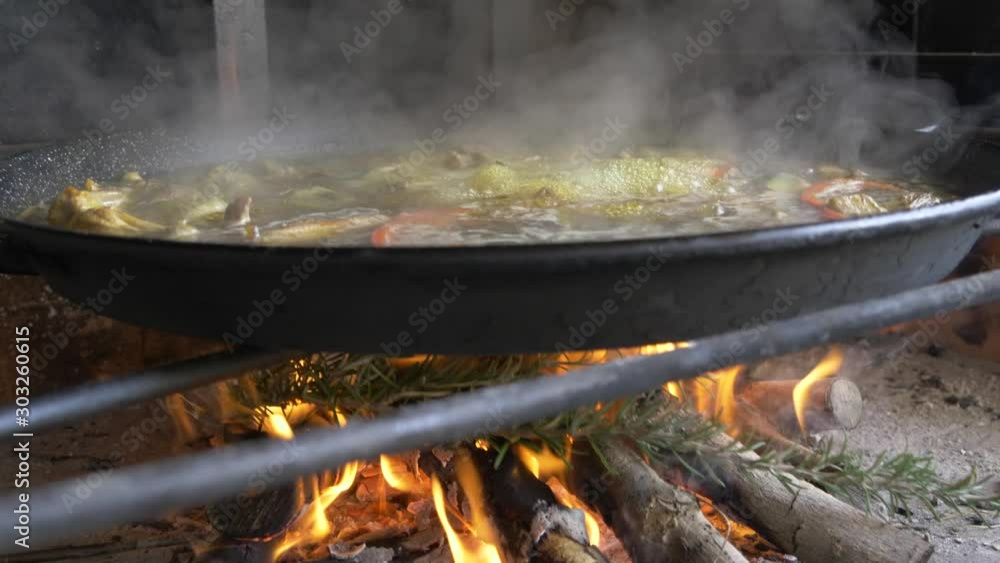 traditional spanish paella cooking on a fire traditional spanish paella cooking on a fire