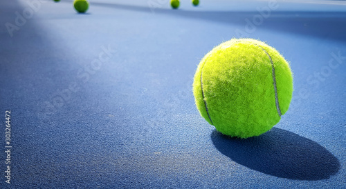 Close-up shots of tennis balls on a blue background field