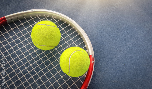 Close up view of tennis racket and balls on the tennis court © Ping198
