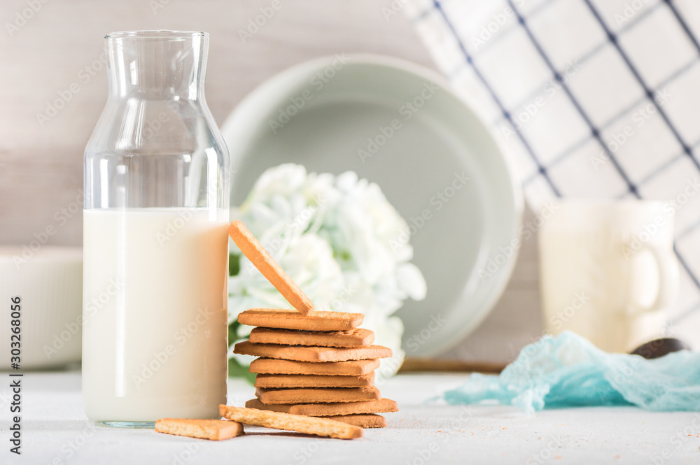 Fresh cookies and milk in bottle on light background Fresh cookies and milk in bottle on light background