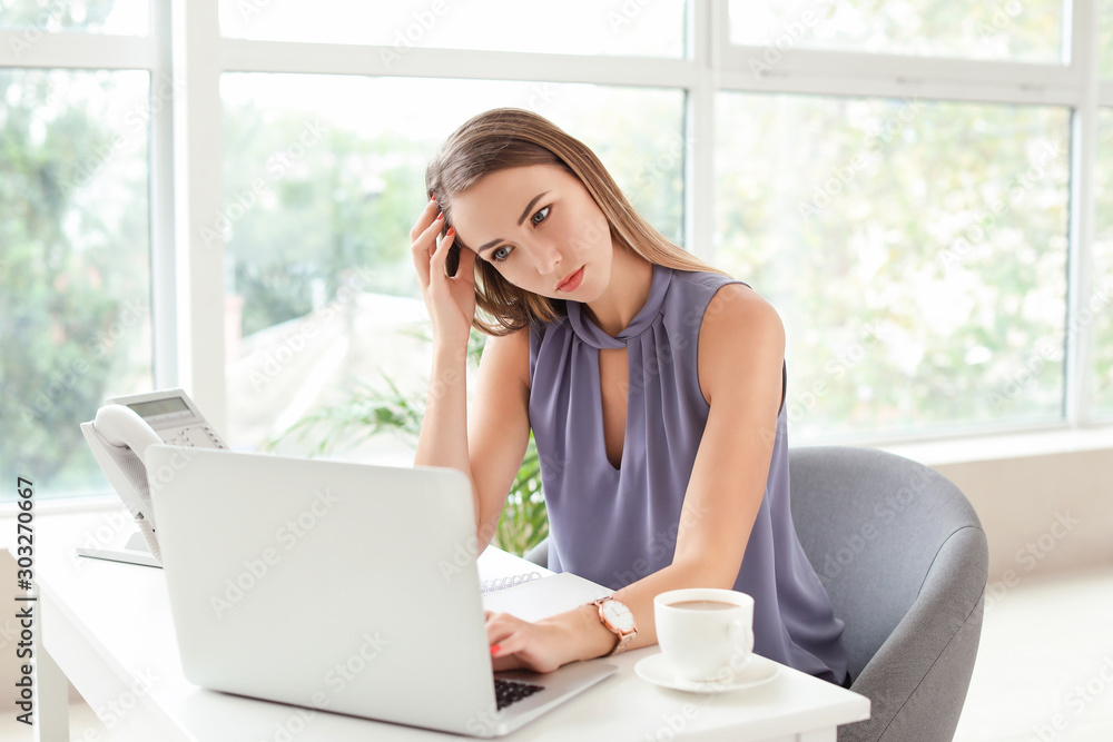 Young woman trying to meet deadline in office Young woman trying to meet deadline in office