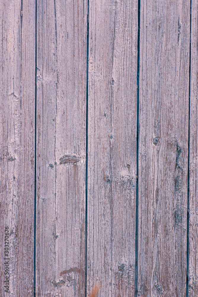 The texture of the old wall of the house of wooden boards painted with pink paint. Peeling paint flakes The texture of the old wall of the house of wooden boards painted with pink paint. Peeling paint flakes