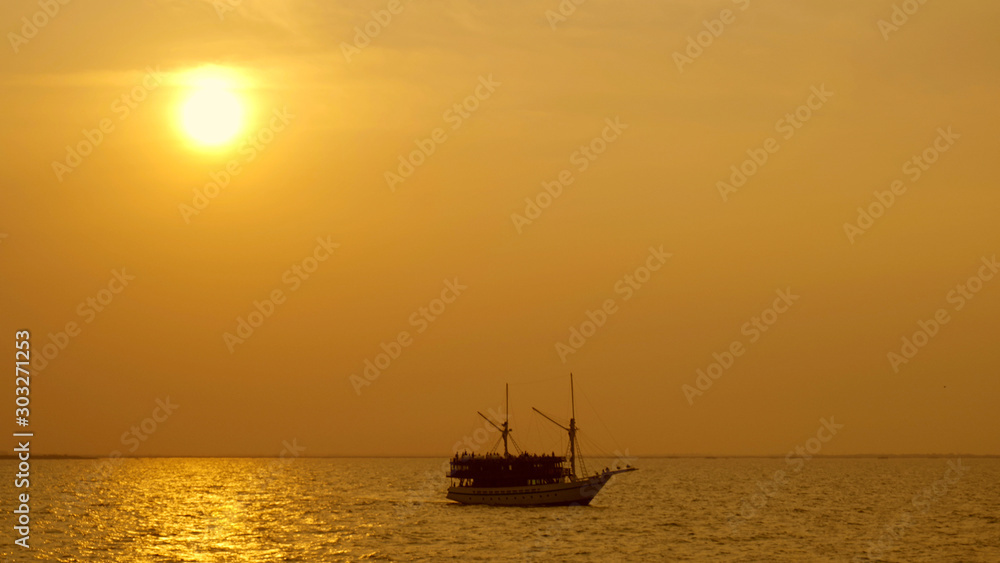 Silhouette of vintage sailboat in the ocean
