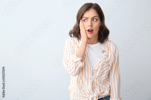 Surprised young woman on li...