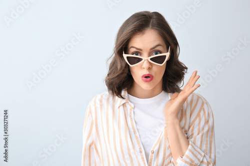 Surprised young woman on li...