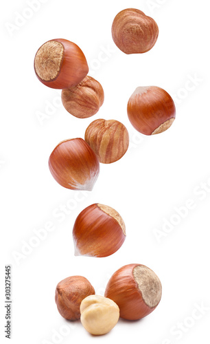 Falling delicious hazelnuts, isolated on white background