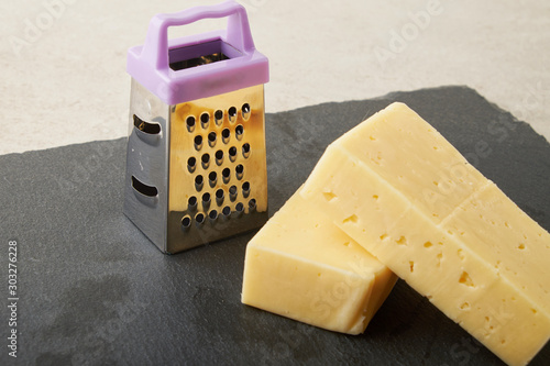 Grated Red Leicester Cheese. Grater. Cooking Ingredient